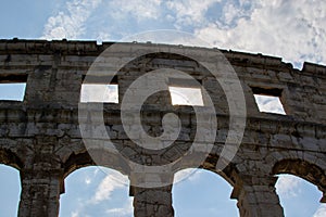 Wall of the Pula Arena, the only remaining Roman amphitheatre entirely preserved, with clouds on the sky at the background, in
