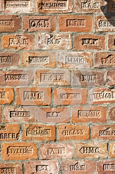 Wall of red bricks from different manufacturers in Tsarist Russia. Shot close up