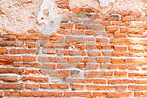 Wall of red old bricks with crack cement