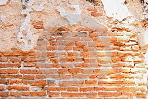 Wall of red old bricks and cracked cement background