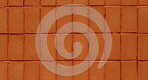 Wall of red tiles close-up. Abstract background. Geometric patte