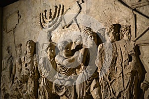 Wall relief on arch of titus depicting Menorah taken from temple in Jerusalem in 70 AD - Israel history, Jewish war