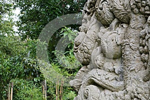 Wall and relief in Bali Indonesia with jungle in the back