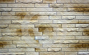 Wall of relief and smooth bricks of light brown color