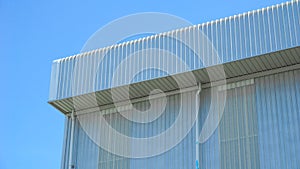 Wall and roof of Factory or warehouse building in industrial estate with blue sky and copyspace