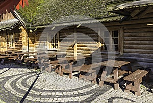 Wall of round logs. Wooden decoration.