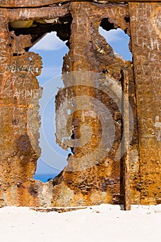 Wall of rust, closeup of a ship wreck at sandy beach, Zakynthos, Greece.