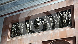 Wall sculpture of Jesus Christ entering Jerusalem on donkey, placed above decorative arches in Primatial Basilica photo