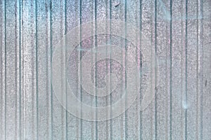 Wall of sheet metal. Blank background with color overflows. Texture of corrugated metal.