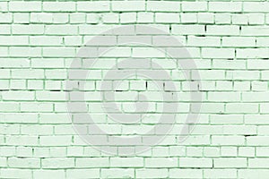 Wall of small light green bricks. The texture of the brickwork. Blank background.