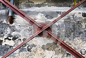 Wall in a steel mill with clear signs of use, cracks and pipes. High resolution background