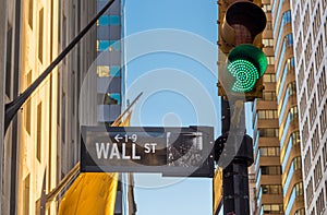 Wall street sign and green light.