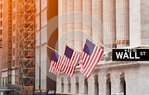 Wall street sign in New York City with New York Stock Exchange background, USA