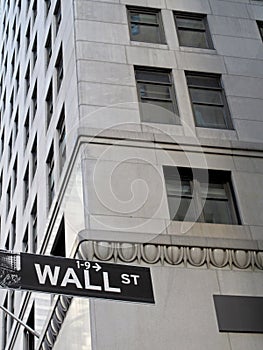 Wall Street sign, with skyscraper in the background, New York City, USA