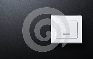 The wall switch is white on a black background.