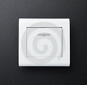 The wall switch is white on a black background.