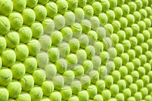 Wall of tennis balls aligned - background