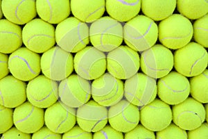 Wall of tennis balls aligned - background