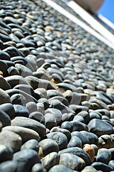 Wall texture decorated with blue pebbles, pebbles glued to the wall