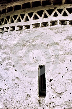 Wall texture and a narrow window of medieval church, Pskov. Russ