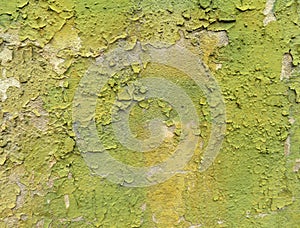 Wall texture with peeling yellow-green paint