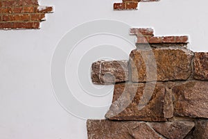 Wall texture. White wall with fragments of brickwork. The photo