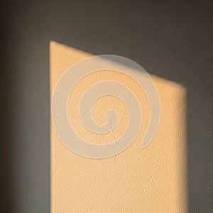 A wall with a textured surface displays a rectangular patch of light