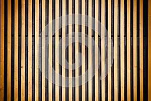 Wall of thin wooden slats. Vertical parallel plates. Background with vignette.