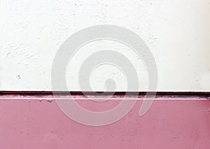 Wall tile with a horizontal seam, painted in white and pink color.