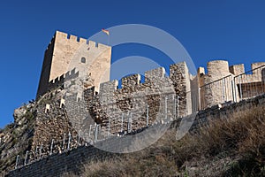 Wall and tower of the Almohad castle of Sax on top of a rock. Sax, Alicante, Spain photo