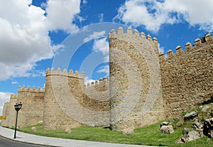 Wall, tower and bastion of Avila, Spain, made of yellow stone bricks