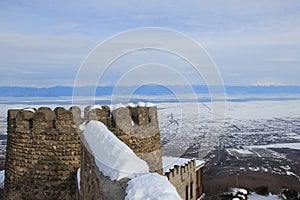The wall and the tower of castle in Sighnaghi town in winter photo