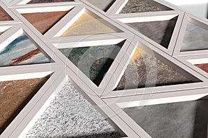 Wall with triangles of different materials in white frames