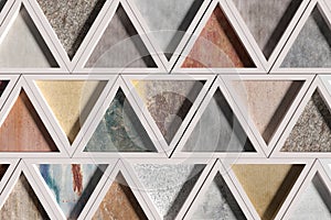 Wall with triangles of different materials in white frames