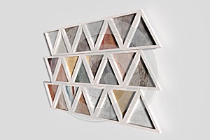 Wall with triangles of different materials in white frames