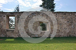 Wall with two different windows in the courtyard of the ex Monastery of Sant`Agostino, Italy photo