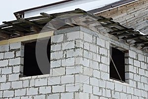 Wall of an unfinished house of white bricks