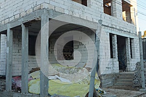 Wall of an unfinished house of white bricks