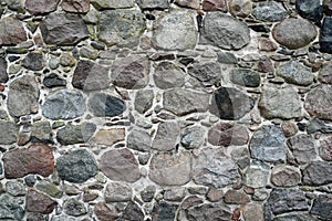 Wall of unregular round shaped granite blocks