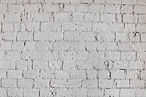 The texture of a wall from a white brick with a regular laying background