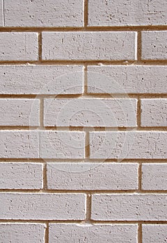 Wall of white bricks with yellow fugue