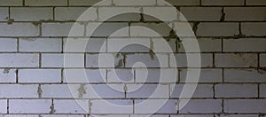 Wall from white cinderblocks. From light to dark, panorama background photo