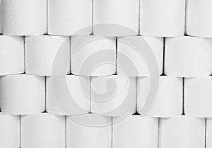 Wall of white toilet paper stacked vertically and horizontally