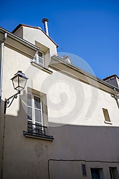 Wall with windows of residential apartments in an old high-rise building overlooking the courtyard at Montmartre in Paris