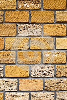 Wall of yellow stone, close-up. Yellow bricks