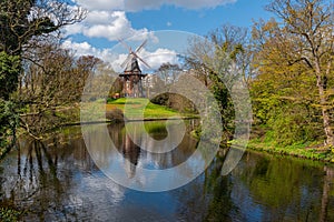 Wallanlagen park with windmill in Bremen in early spring. Germany. Nature landscape.