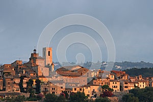 Walled hilltop village lit by sun's first rays photo