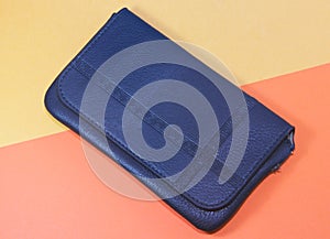 Wallet blue on yellow-orange texture surface