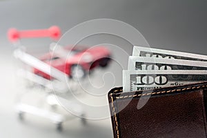 wallet with dollars red car shopping trolley