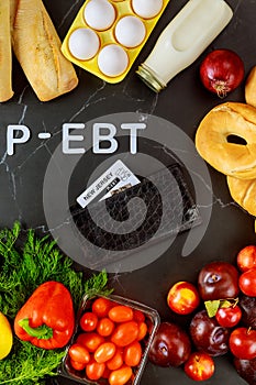 Wallet with ebt card and healthy produce on table